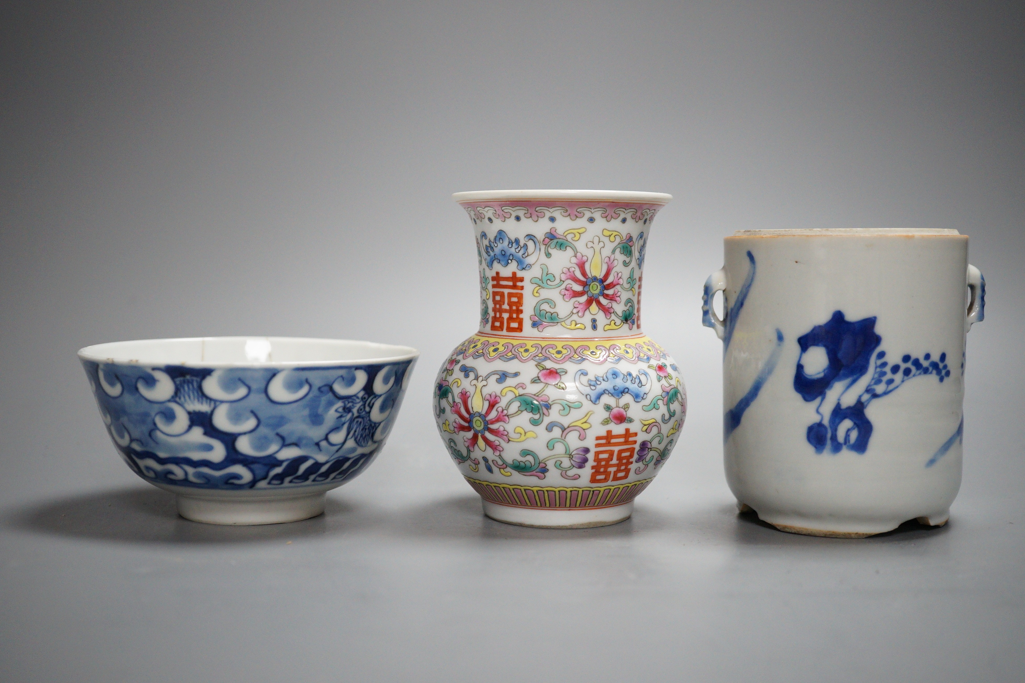 An early 20th century Chinese famille rose vase, a Chinese blue and white jar, lacking cover and a blue and white bowl